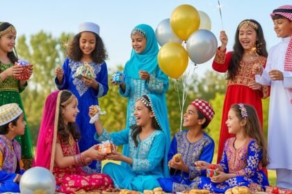 Happy children celebrating Eid in traditional festive clothing with smiles and excitement